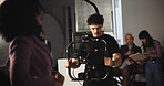 Man, cameraman and stabilizer with journalist on set of broadcast, production process and record. People, tech and cinematographer for shooting news, documentary footage and rehearsal for commercial