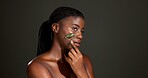 Gua sha roller, skincare and black woman in studio for smooth skin, facial and anti aging. Dermatology, space and person with jade tools for beauty, facelift and lymphatic drainage on dark background