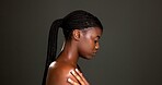 Beauty, shoulder and profile of black woman in studio for skincare, hydration and glow. Shine, aesthetic and dermatology with person on dark background space for  hygiene, clear skin and body care