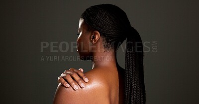 Buy stock photo Beauty, glow and shoulder with back of black woman in studio for skincare, smooth texture or dermatology. Hygiene, aesthetic and shine with person on dark background space for hydration and body care