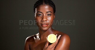 Buy stock photo Black woman, portrait and skincare with lemon in studio for beauty on a dark background. Face, female person or African model with natural organic citrus fruit for vitamin C or body health on space
