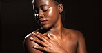 Skincare, beauty and black woman in studio for body care, satisfaction and spa wellness. Space, dark background and person with smooth skin, glow and shine for hydration, dermatology and cosmetics
