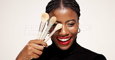 Buy stock photo Studio, makeover and woman with makeup brush, portrait and equipment for beauty, happy and selfcare. White background, black person and cosmetic for self expression, creative and tools for foundation