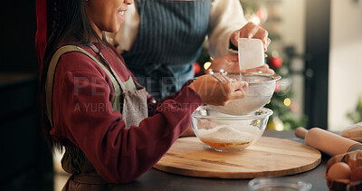 Buy stock photo Baking, mother and child with sieve on Christmas for holiday cake recipe, dough preparation or help. Happy family, people and mix ingredients in home for xmas dessert, festive celebration or learning