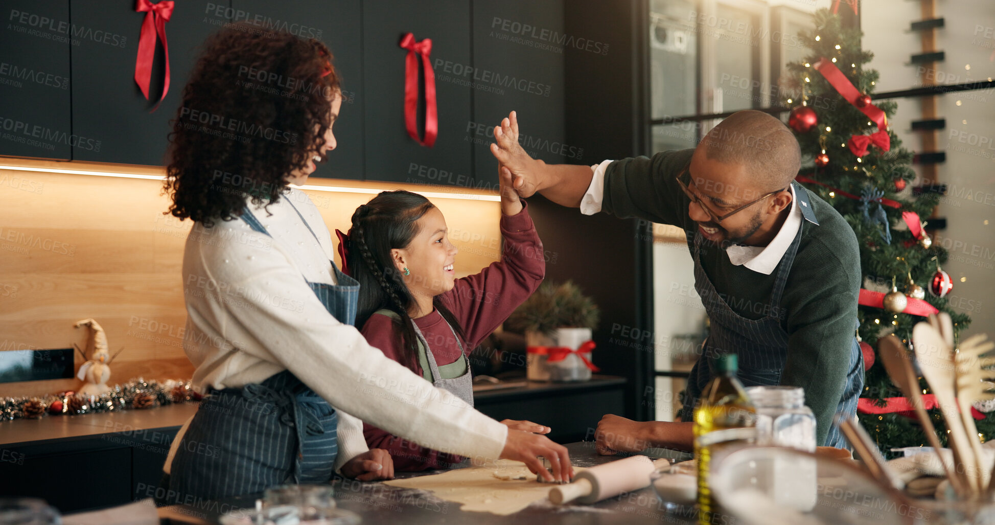 Buy stock photo Christmas, baking and family with girl, high five and bonding together with support, home and festive. African parents, mother or father with daughter, Xmas or tradition with ingredients or gesture