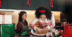 Christmas, child and mother wrapping gifts in home for holiday tradition, celebration and bonding. Happy family, people and packaging present in apartment for festive season, appreciation and support