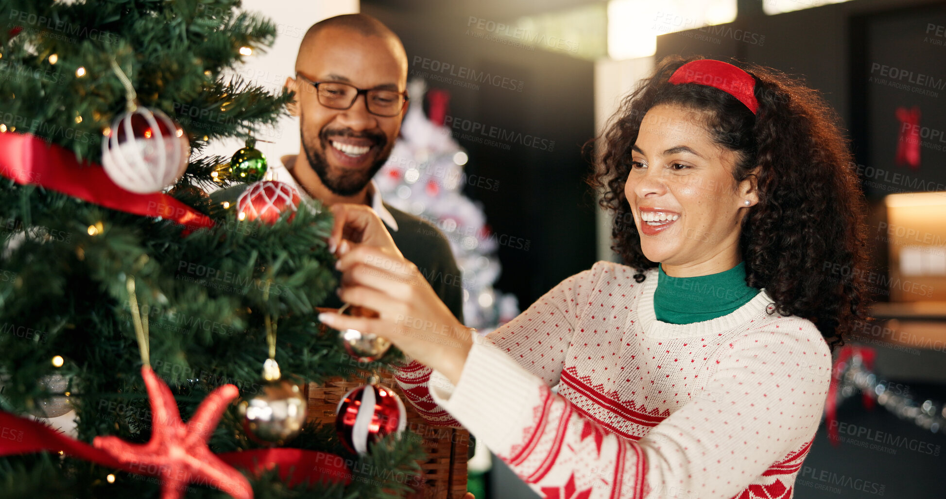 Buy stock photo Couple, happy and Christmas tree decoration in home for festive tradition, holiday and support. Love, African people and hang bauble ornaments in lounge for xmas aesthetic, bonding and celebration