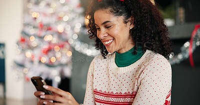 Buy stock photo Christmas, woman and typing with phone in home for holiday text, season greeting and chat. Happy, person and relax with smartphone in house for online shopping and search donation site for charity