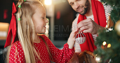 Buy stock photo Christmas tree, father and girl with ball for decoration for festive holiday, family tradition or help. Child, man and ornament in home for celebration, happiness and xmas bauble for bonding
