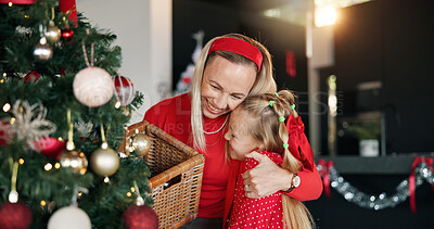 Buy stock photo Hug, mother and girl with Christmas decoration for festive holiday, family tradition or help. Child, woman and tree ornament in home for celebration, happiness and affection for bonding