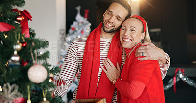 Buy stock photo Christmas, decoration and hug with interracial couple in living room of home for celebration. December, event and tree with people embracing in apartment together for festive tradition or holidays