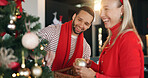 Christmas, decoration and smile of interracial couple in living room of home for celebration. December, event and tree with happy people in apartment together for festive tradition or holidays
