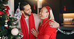 Christmas tree, hug and laughing with interracial couple in living room of home for celebration. December, decoration and funny with people embracing in apartment together for festive holidays