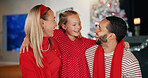 Christmas, happy family and parents hug child for love, celebration and funny joke. Embrace, mother and father with girl for xmas holiday, bonding and laughing together in home for festive tradition