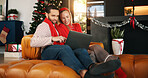 Christmas, home and couple with laptop, smile and search for gifts, festive and online website. Connection, love and man with woman, tech and entertainment with holiday season, internet and Xmas