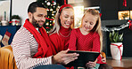 Home, happy family and kid with tablet for Christmas film, gift shopping and festive cartoon. Technology, mother and father with girl for xmas movie, bonding and present choice with parents online