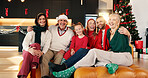 Portrait, smile and family in home for christmas memory, celebration or relaxing together. Happy, holiday and girl child with parents and grandparents on sofa for xmas, event or festive season.