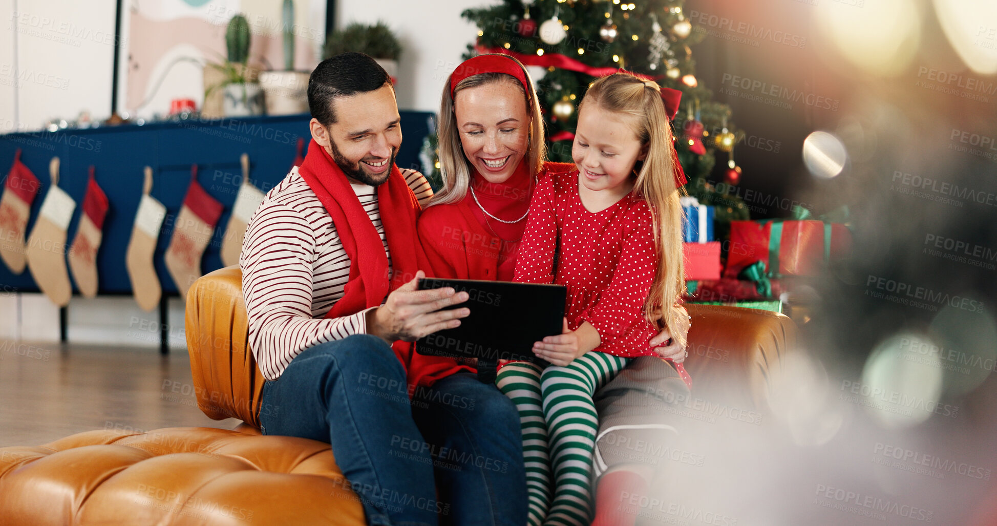 Buy stock photo Christmas, happy family and kid with tablet for relax, gift shopping and watch cartoon on holiday. Tech, mom and dad with girl for xmas movie, bonding and present choice with parents online in home