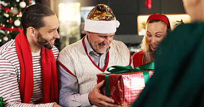 Buy stock photo Christmas, home and family in lounge, gift and excited with smile, bonding together and festive. Group, celebration and Xmas with happy people, present and surprise with holiday season or tradition