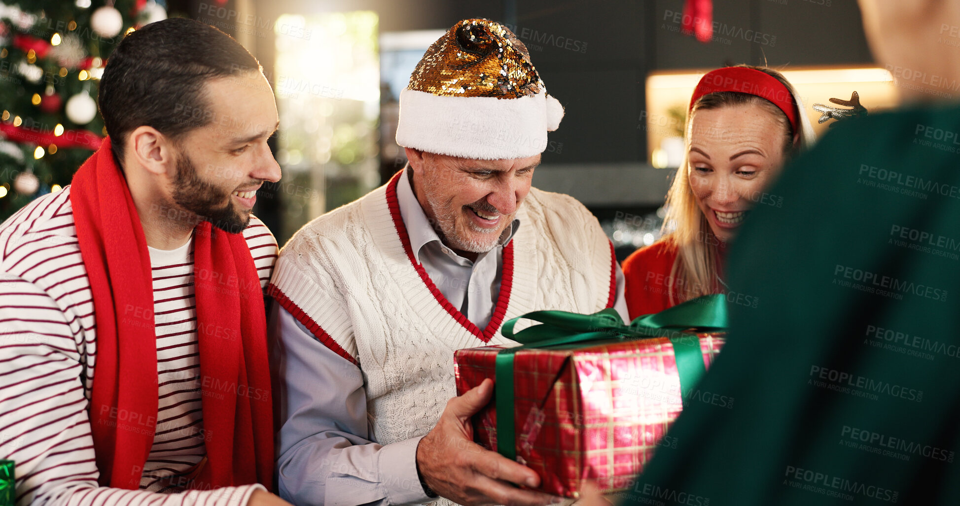 Buy stock photo Christmas, home and family in lounge, gift and excited with smile, bonding together and festive. Group, celebration and Xmas with happy people, present and surprise with holiday season or tradition