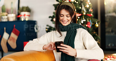 Buy stock photo Happy woman, christmas and social media with phone for festive holiday, weekend or chat in home. Female person, celebration and smile with mobile smartphone app for December party or santa in house