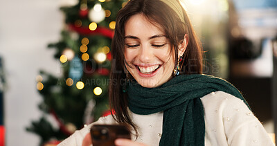 Buy stock photo Christmas, phone and smile with woman on sofa for online shopping, xmas discount and gift research. Holiday season, festive deals and bokeh with person and mobile in living room of home for happiness