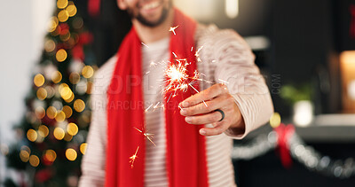 Buy stock photo Hand, man and sparkler for Christmas celebration, festive holiday and home with bokeh. Xmas, fireworks and happy person in lounge for new year event, December season and glow for party with tradition