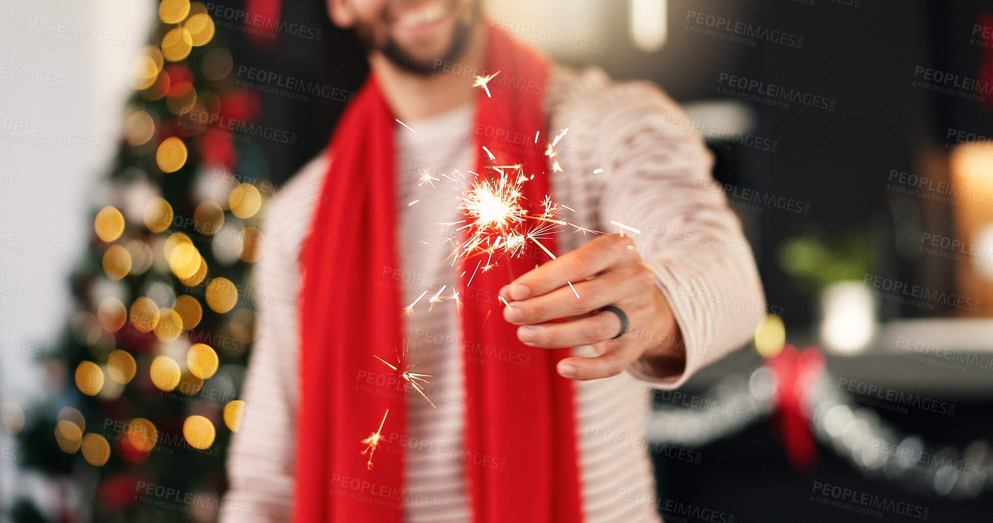 Buy stock photo Hand, man and sparkler for Christmas celebration, festive holiday and home with bokeh. Xmas, fireworks and happy person in lounge for new year event, December season and glow for party with tradition