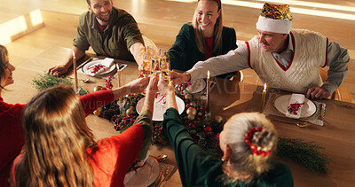 Buy stock photo Cheers, champagne and family in home for Christmas, celebration or event in dining room. Toast, festive season and group of people with sparkling wine for xmas party with bonding in house together.