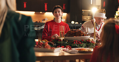 Buy stock photo Happy family, night and christmas with feast for meal, food or eating together at dining table. Group, people and festive celebration with dinner for hospitality, december holiday or weekend in house