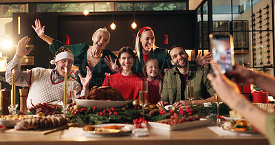 Buy stock photo Christmas, family and photograph at dinner in home for holiday memory, festive party and bonding. Support, happy people and picture at dining table for xmas lunch, social media post and celebration