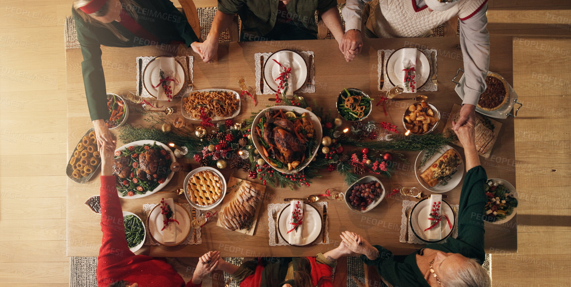 Buy stock photo Holding hands, praying and people in home, dinner or gratitude for food on Christmas or celebration. Above, faith and prayer for feast on holiday, group and family in house for thanksgiving and night