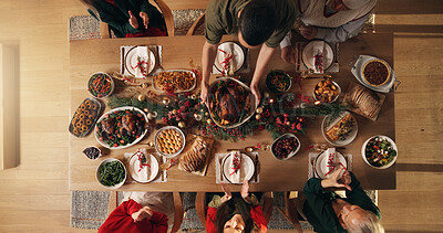 Buy stock photo Festive, reunion and people in home, dinner and celebration of Christmas with food at night or meal. Above, group and family with feast for thanksgiving, evening and together on holiday in house