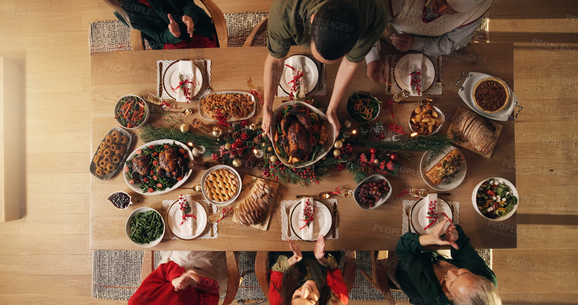Buy stock photo Festive, reunion and people in home, dinner and celebration of Christmas with food at night or meal. Above, group and family with feast for thanksgiving, evening and together on holiday in house