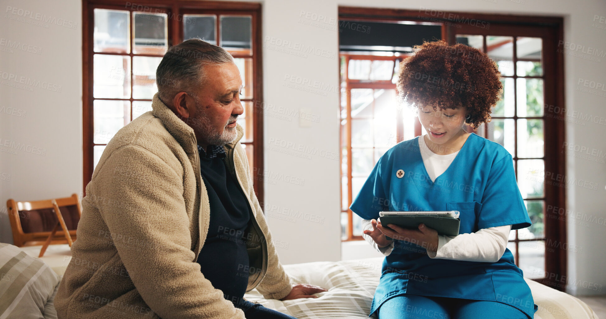 Buy stock photo Senior man, caregiver and consulting with tablet on bed for schedule activity in retirement home. Nurse, help and discussion with elderly patient on technology for daily plan or routine in bedroom