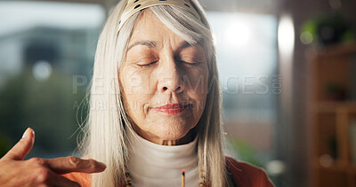 Buy stock photo Zen, woman and smell aroma of incense stick for peaceful atmosphere, aura cleanse and aromatherapy. Relax, mature person and inhale fragrance in home for holistic healing, self care and stress relief