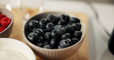 Buy stock photo Food, home and bowl of blueberries on table for healthy eating, nutrition and wellness in kitchen. Closeup, vegan and fruit for organic snack, breakfast and meal for vitamins, benefits and diet