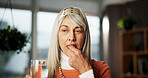 Senior woman, medicine and water at house for prescription, supplements and healing benefits. Thinking, elderly person and beverage with pills for vitamins, recovery drugs and treatment for wellness