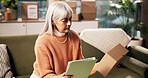 Tablet, mature woman and check box for ecommerce, logistics and online app for order with remote work. Package, technology and freelance entrepreneur in home for stock, shipping or quality control