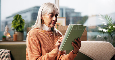 Buy stock photo Senior woman, tablet and relax on sofa in living room for ebook, article or web subscription service in home. Person, tech and scroll for movie streaming, app or social network in lounge at house