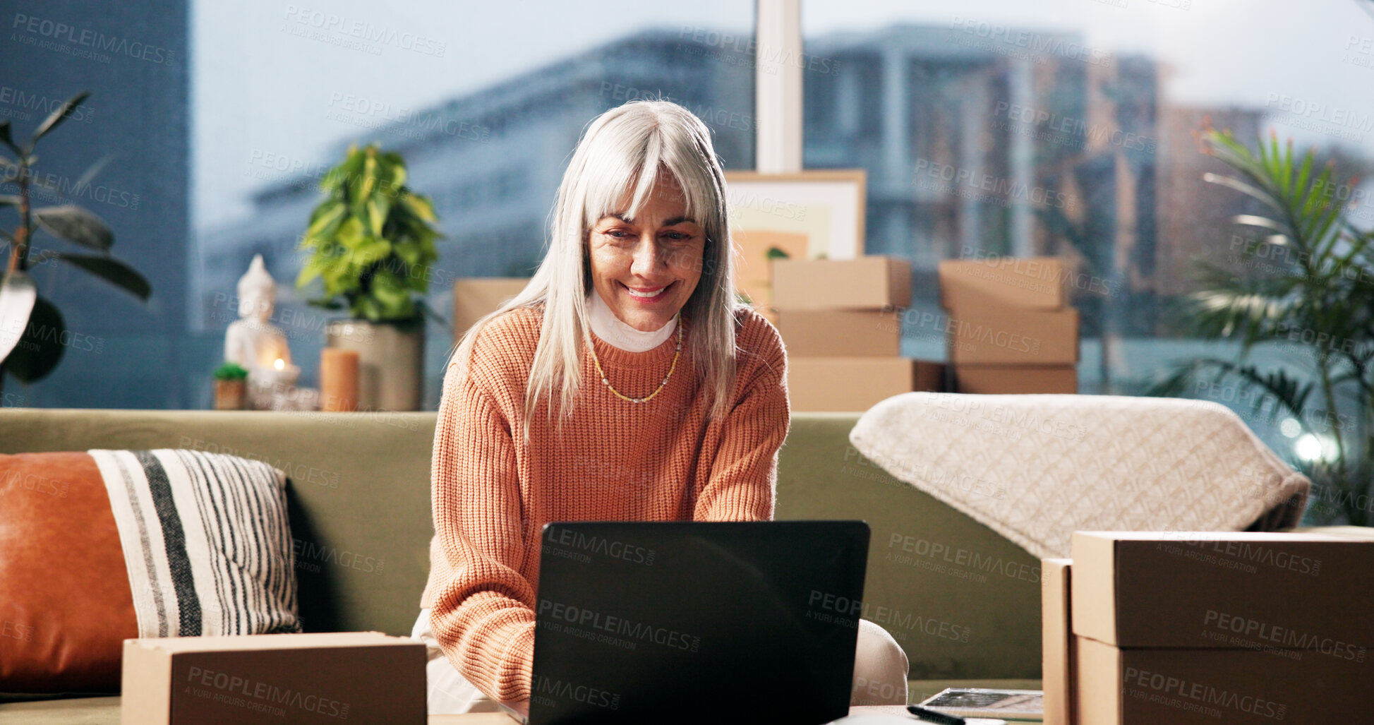 Buy stock photo Laptop, mature woman and smile for ecommerce, logistics and check online for order with remote work. Package, technology and freelance entrepreneur in home for stock, shipping or quality control