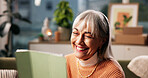 Elderly woman, happy and tablet in home with ebook, funny story and social media connection. Senior person, technology and laugh in living room for retirement blog, comedy video and reading message