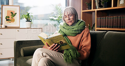 Buy stock photo Senior woman, relax and reading book on sofa for birdwatching hobby, learning and info at retirement home. Person, literature and study for avian animal, knowledge or thinking on couch at apartment