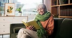 Senior woman, happy and reading book on sofa for birdwatching hobby, learning and info at retirement home. Person, literature and study for avian animal, knowledge or relax on couch at apartment