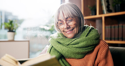 Buy stock photo Senior woman, smile and reading book on sofa with story, poetry or novel in living room at house. Person, happy and relax with literature, knowledge or info on couch in lounge at retirement home