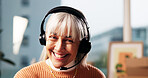 Mature, happy woman and consultant with headset for online communication or advice in office. Female person, agent or smile with mic for customer service, network or telecommunications in workplace