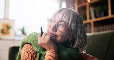 Buy stock photo Writer, mature woman and thinking in home for story inspiration, creative process and planning. Remote work, smile and freelance author with pen for plot development, fantasy novel and imagination