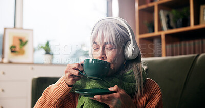 Buy stock photo Senior woman, drinking coffee and headphones on sofa with smile, audio or inspiration in retirement home. Person, relax and listen to music with subscription, streaming or tea in lounge at house