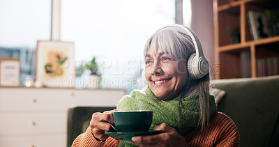 Buy stock photo Senior woman, coffee and headphones on sofa with smile, thinking and listen to music in retirement home. Person, relax and happy with drink, beverage or tea cup with audio streaming on couch in house