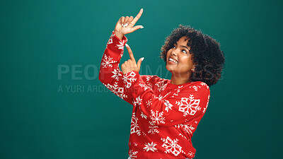 Buy stock photo Christmas, pointing and smile with woman in studio for holiday season, celebration and promotion. Festive deals, xmas event and announcement with person on green background space for mockup and offer